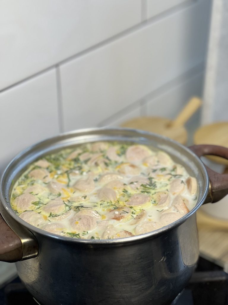 Вершковий суп з сосисками та овочами у каструлі
